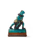 A Chinese turquoise and aubergine glazed ridge tile figure of a Demon