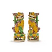 A pair of Chinese sancai porcelain lion dog taperstick holders