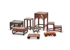 A group of eight carved wood stands