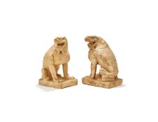 A pair of Chinese white marble figures of seated lions