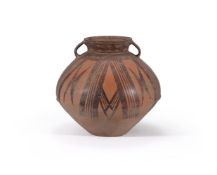 A Chinese red painted pottery twin handled vase