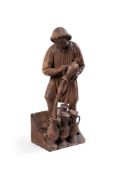A CARVED OAK FIGURE OF A SERVANT POURING WINE AT THE WEDDING FEAST AT CANA. FLEMISH
