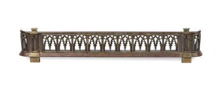 AN EARLY VICTORIAN BRASS MOUNTED POLISHED STEEL 'GOTHIC' FENDER, MID 19TH CENTURY