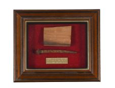 A CASED DECK SPIKE AND OAK FRAGMENT FROM H.M.S VICTORY