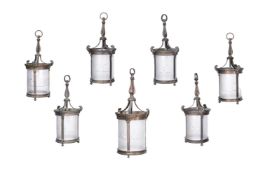 A SET OF SEVEN EDWARDIAN GILT BRONZE AND FROSTED GLASS HANGING LANTERNS, FIRST QUARTER 20TH CENTURY