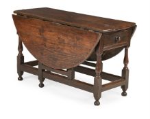 A CHARLES II ELM AND OAK GATELEG DINING TABLE, CIRCA 1680