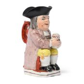 A STAFFORDSHIRE PEARLWARE PIPE-SMOKING TOBY JUG, CIRCA 1830