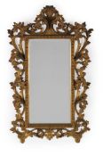 A CARVED AND GILT WOOD WALL MIRROR, IN FLORENTINE STYLE, EARLY 20TH CENTURY