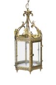 A GILT BRASS OCTAGONAL HANGING HALL LANTERN WITH GLAZED PANELS, FIRST HALF 20TH CENTURY