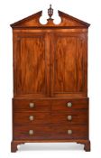 A GEORGE III MAHOGANY LINEN PRESS WITH A CARVED ARCHITECTURAL PEDIMENT, CIRCA 1790