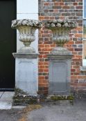 A PAIR OF CARVED LIMESTONE PEDESTAL URNS, EARLY 20TH CENTURY