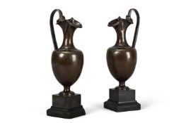 A PAIR OF REGENCY BRONZE EWERS ON MARBLE BASES, EARLY 19TH CENTURY