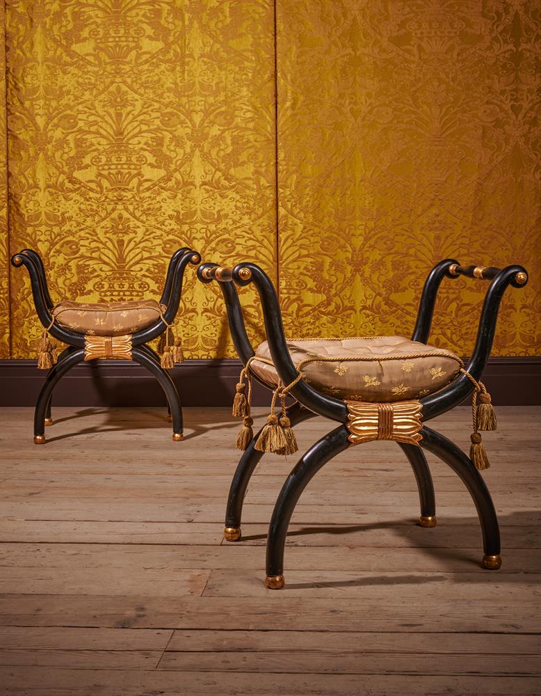 A PAIR OF REGENCY EBONISED AND PARCEL GILT X-FRAME WINDOW SEATS, CIRCA 1815
