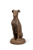 A BRONZED COMPOSITION STONE SEATED WHIPPET DOOR STOP OR DOOR PORTER, 20TH CENTURY