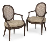 A PAIR OF GEORGE III MAHOGANY LIBRARY ARMCHAIRS, IN THE MANNER OF THOMAS CHIPPENDALE, CIRCA 1790