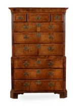A GEORGE II WALNUT AND FEATHERBANDED CHEST ON CHEST, CIRCA 1730
