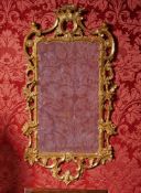 A GEORGE III CARVED GILTWOOD MIRROR, CIRCA 1780