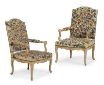 A PAIR OF LOUIS XV CREAM PAINTED, PARCEL GILT AND NEEDLEWORK UPHOLSTERED ARMCHAIRS, CIRCA 1765