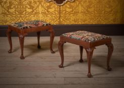 A PAIR OF GEORGE II CARVED MAHOGANY AND NEEDLEWORK UPHOLSTERED STOOLS, CIRCA 1740