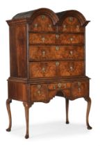 A GEORGE I WALNUT AND FEATHERBANDED DOUBLE-DOMED CHEST ON STAND, CIRCA 1715