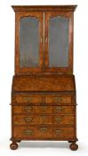 A GEORGE I BURR WALNUT AND FEATHERBANDED BUREAU BOOKCASE, CIRCA 1720