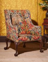 A FINE GEORGE II CARVED MAHOGANY AND NEEDLEWORK UPHOLSTERED WING ARMCHAIR, CIRCA 1740