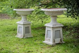 A LARGE PAIR OF CAST IRON FLUTED PEDESTAL URNS, 19TH CENTURY