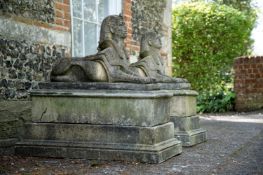 A PAIR OF COMPOSITION STONE SPHINXES, IN REGENCY STYLE, LATE 20TH CENTURY