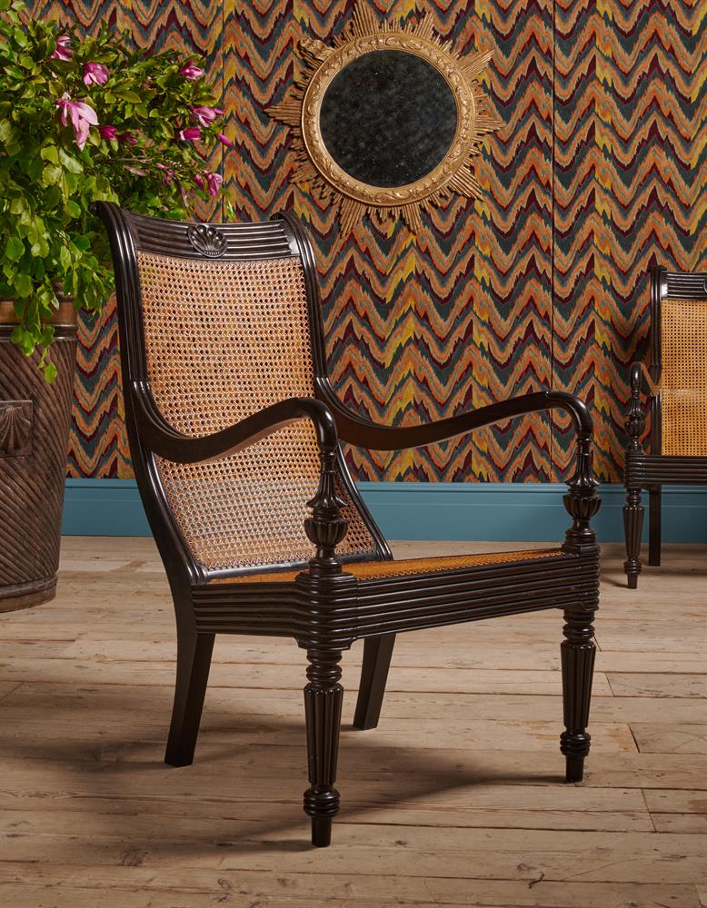 A CLOSELY MATCHED PAIR OF CEYLONESE CARVED EBONY ARMCHAIRS, FIRST HALD 19TH CENTURY