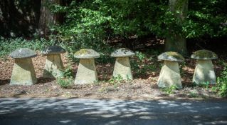 A SET OF SIX COMPOSITION STONE STADDLE STONES, 20TH CENTURY