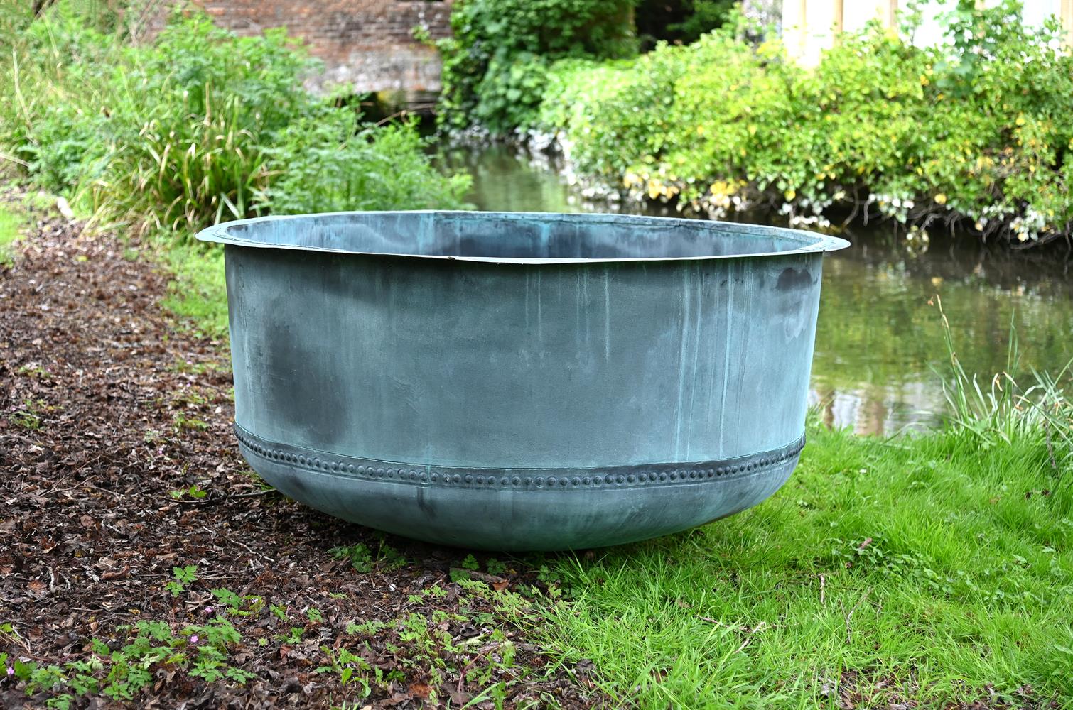 A VERY LARGE PATINATED COPPER AND RIVETED CIRCULAR PLANTER, CONTEMPORARY