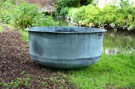 A VERY LARGE PATINATED COPPER AND RIVETED CIRCULAR PLANTER, CONTEMPORARY