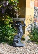 A LEAD FIGURE OF A BOY AND DOG SUPPORTING A PORTLAND STONE BIRD BATH, EARLY 20TH CENTURY