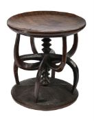 A RARE CARVED IROKO IGBO EKEWE STOOL, SOUTH EASTERN OR SOUTH CENTRAL NIGERIA, CIRCA 1910