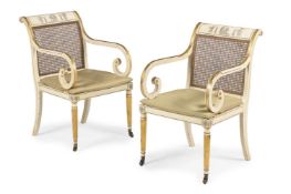 A PAIR OF PAINTED AND PARCEL GILT OPEN ARMCHAIRS, IN THE REGENCY STYLE, CIRCA 1900