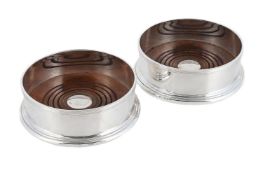 A PAIR OF SCOTTISH SILVER MOUNTED WINE COASTERS