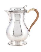 A SILVER OVAL BALUSTER SHAVING JUG
