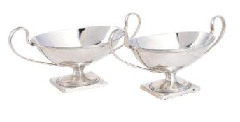 A PAIR OF SILVER TWIN HANDLED OVAL PEDESTAL SALTS
