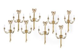 A SET OF EIGHT GILT METAL TWIN BRANCH WALL LIGHTS, IN LOUIS XVI STYLE, 20TH OR 21ST CENTURY