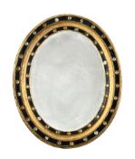 AN IRISH REGENCY OVAL WALL MIRROR, EARLY 19TH CENTURY