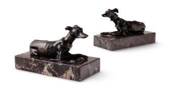 A PAIR OF BRONZE RECUMBENT GREYHOUNDS OR WHIPPETS