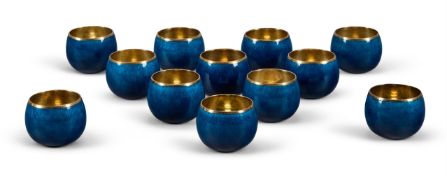 GERALD BENNEY (1930-2008), A SET OF TWELVE SILVER AND BLUE ENAMEL VODKA TOT CUPS