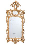 A CARVED GILTWOOD MIRROR IN THE GEORGE III STYLE