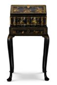 A GEORGE II BLACK AND GILT JAPANNED BUREAU ON STAND, CIRCA 1720