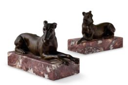 A LARGE PAIR OF BRONZE RECUMBENT GREYHOUNDS OR WHIPPETS
