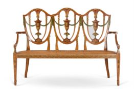 A LATE VICTORIAN POLYCHROME PAINTED SATINWOOD TRIPLE CHAIR BACK SETTEE