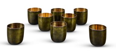 GERALD BENNEY (1930-2008), A SET OF EIGHT SILVER AND GREEN ENAMEL BEAKERS