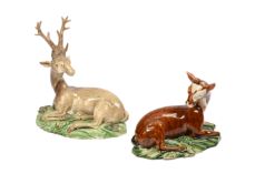 A STAFFORDSHIRE CREAMWARE MODEL OF A RECUMBENT STAG, ALONG WITH A SIMILAR MODEL OF A RECUMBENT DOE
