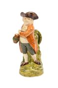 A STAFFORDSHIRE CREAMWARE 'HEARTY GOODFELLOW' TOBY JUG, CIRCA 1800