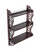 A FLIGHT OF MAHOGANY THREE TIER GRADUATED HANGING SHELVES, IN GEORGE III STYLE